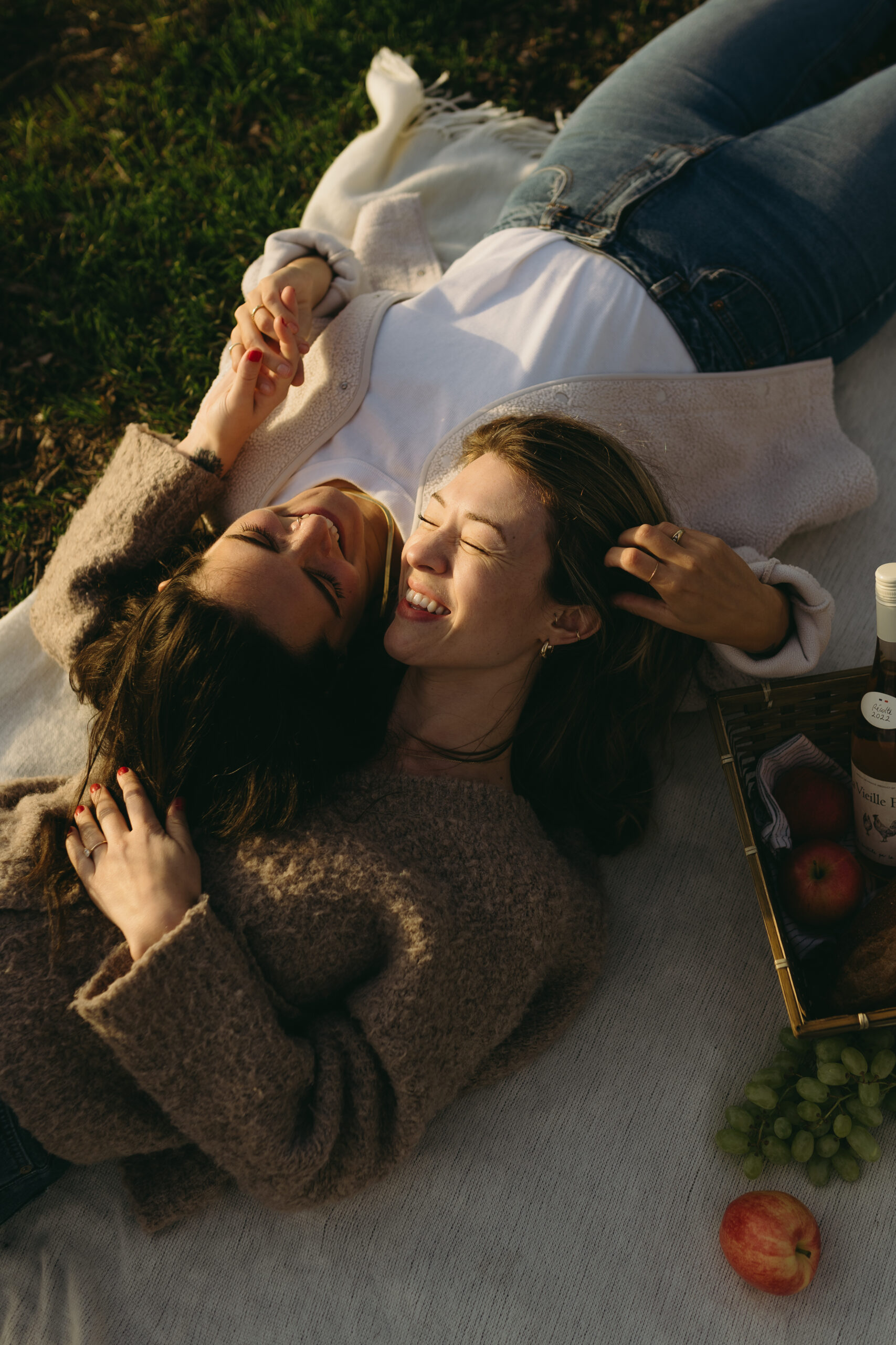LGBTQ+ couple picnic-themed engagement photo