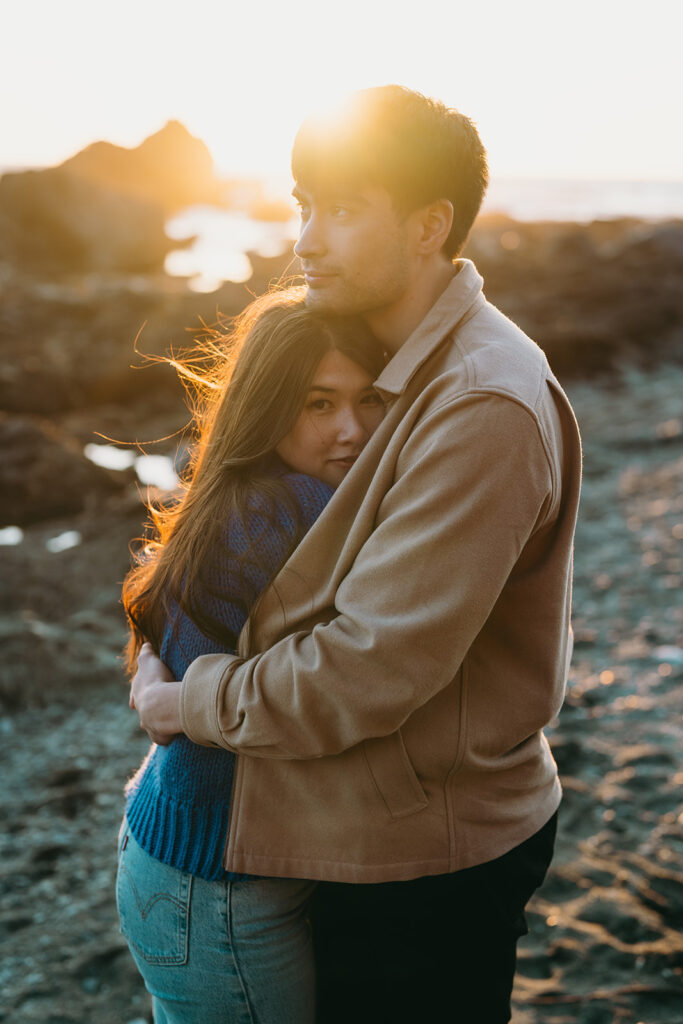 Engagement photo of couple embracing at Sombrio Beach on Vancouver Island