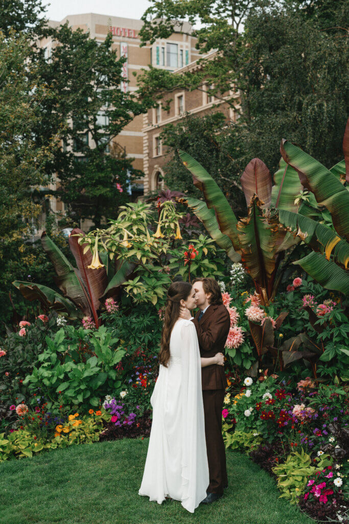 Bride and groom kissing in the gardens of the Empress Hotel