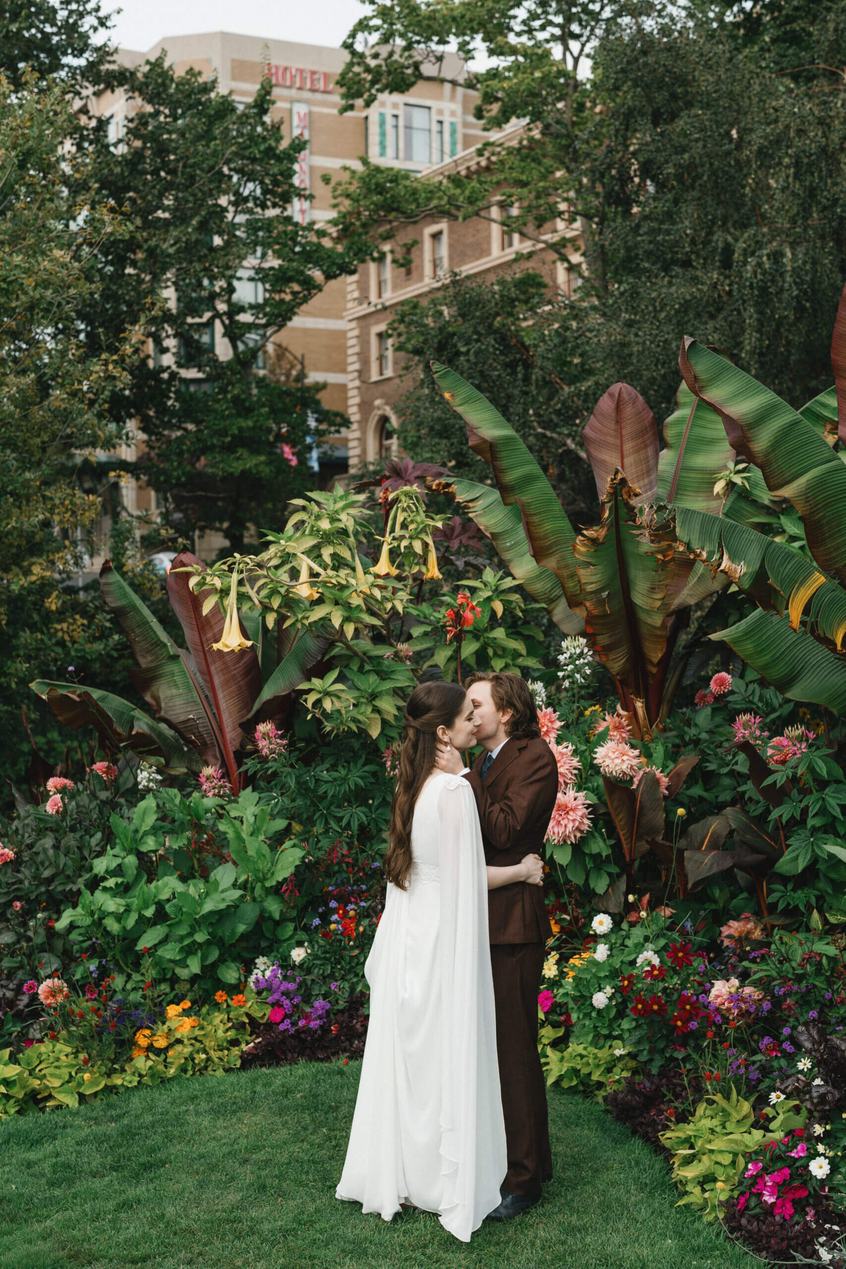 Bride and groom kissing in the gardens of the Empress Hotel